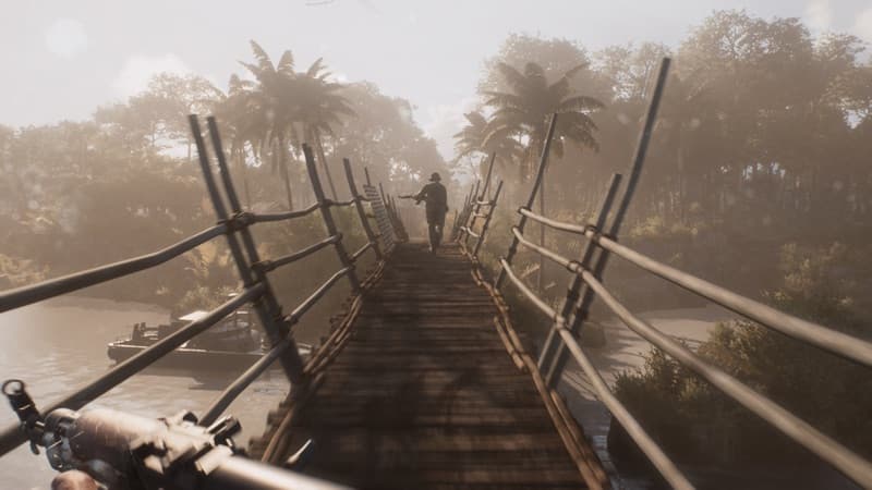 A soldier crossing a narrow bridge over jungle water